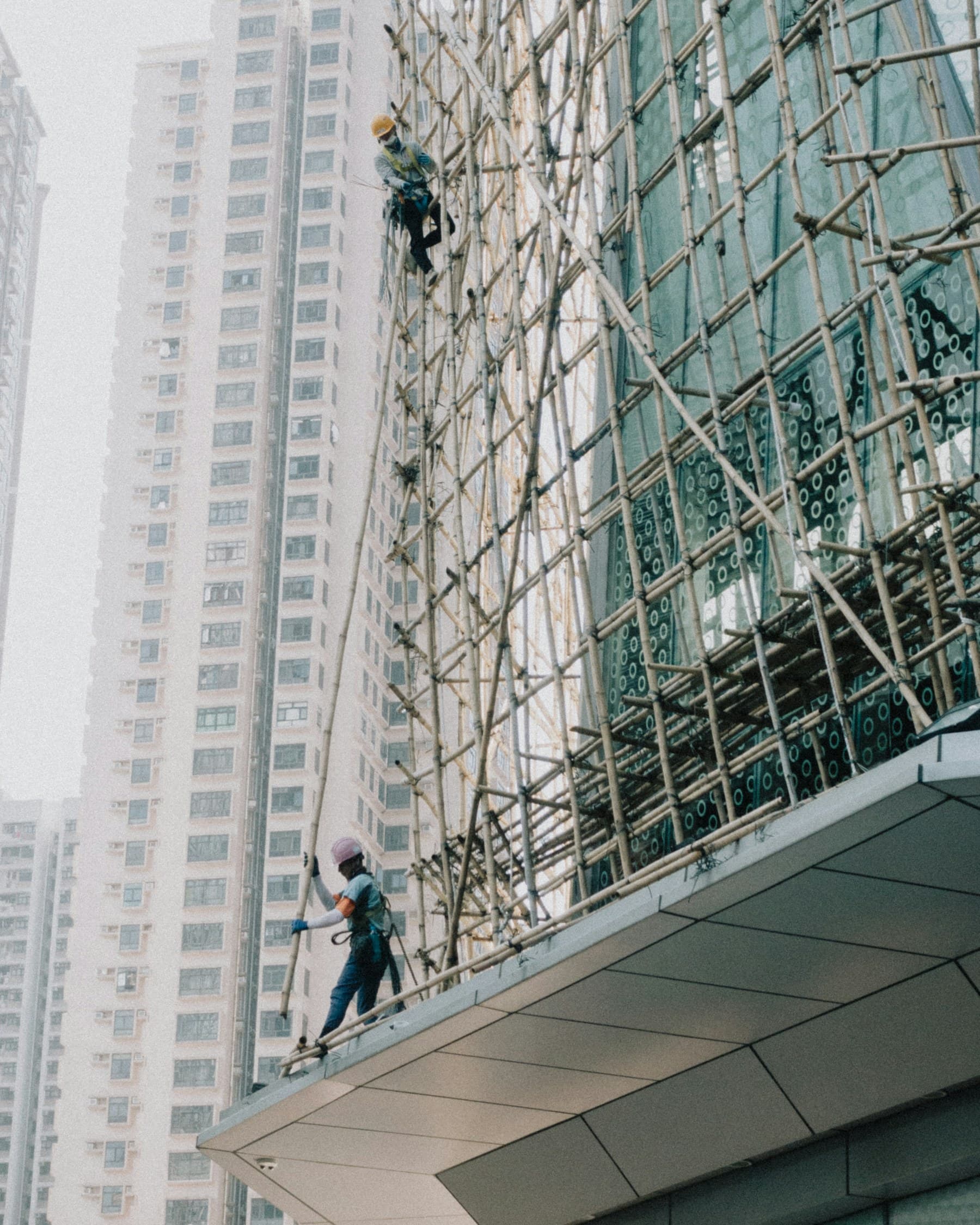 Construction worker using scaffolding on an urban building site